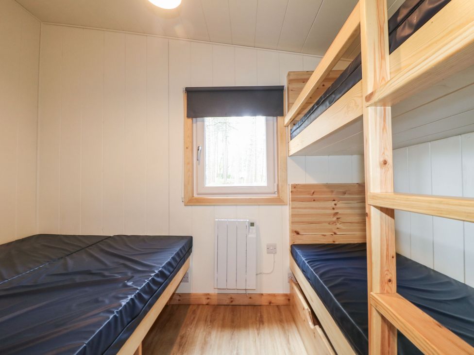 A bedroom with a bunk bed and single bed at Sherwood Pines - Family Pod 5 near Edwinstowe