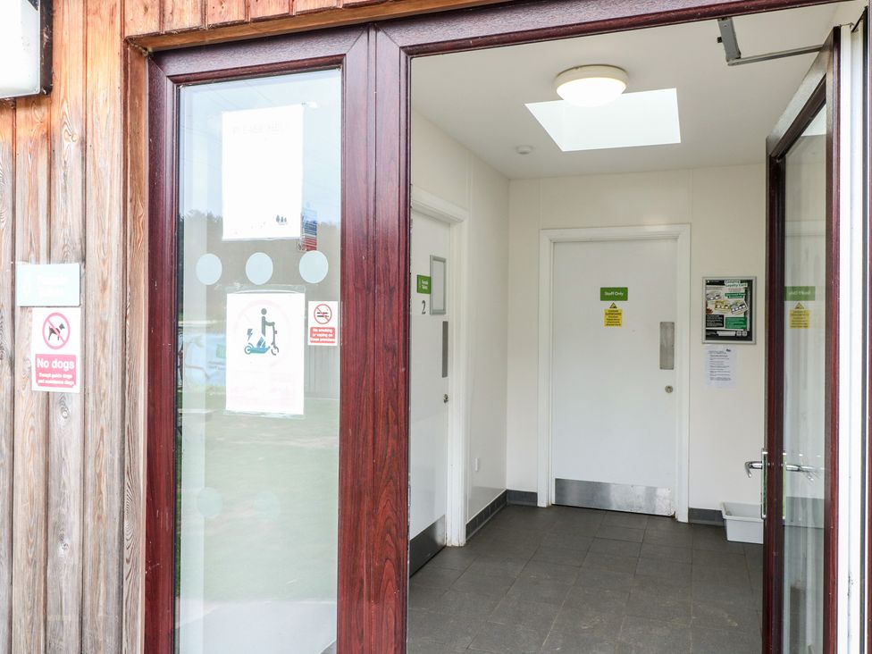 An entrance hallway with doors and signs at Sherwood - Deluxe Pod 1 in Mansfield