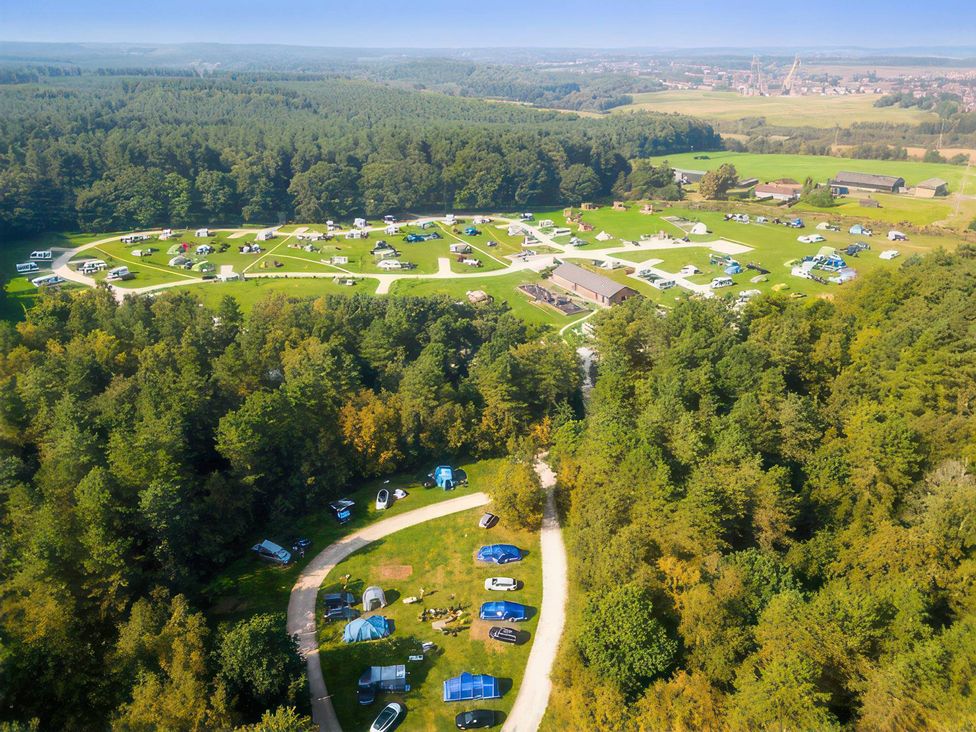 A campsite with tents and caravans at Sherwood Pines - Deluxe Pod 1 near Edwinstowe
