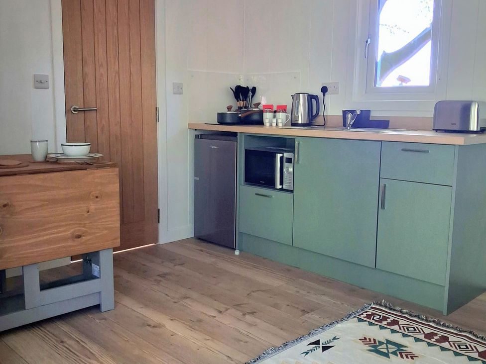A kitchen with cabinets, sink, toaster, and microwave at Sherwood Pines - Deluxe Pod 2 near Edwinstowe