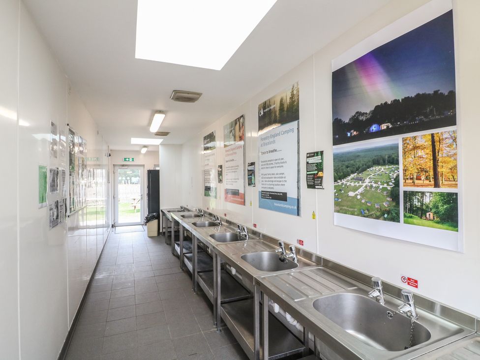 A kitchen with sinks and informational posters at Sherwood - Deluxe Pod 3 in Mansfield