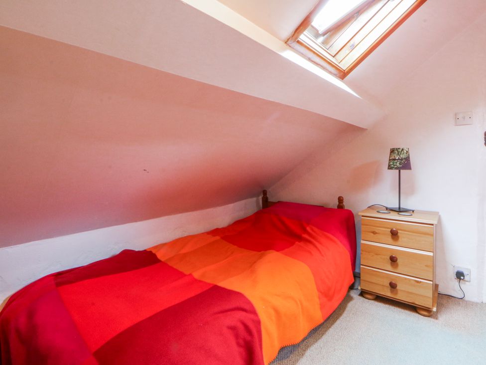 A bedroom with a bed and drawer at Llwyn Y Brig Isaf in Caernarfon