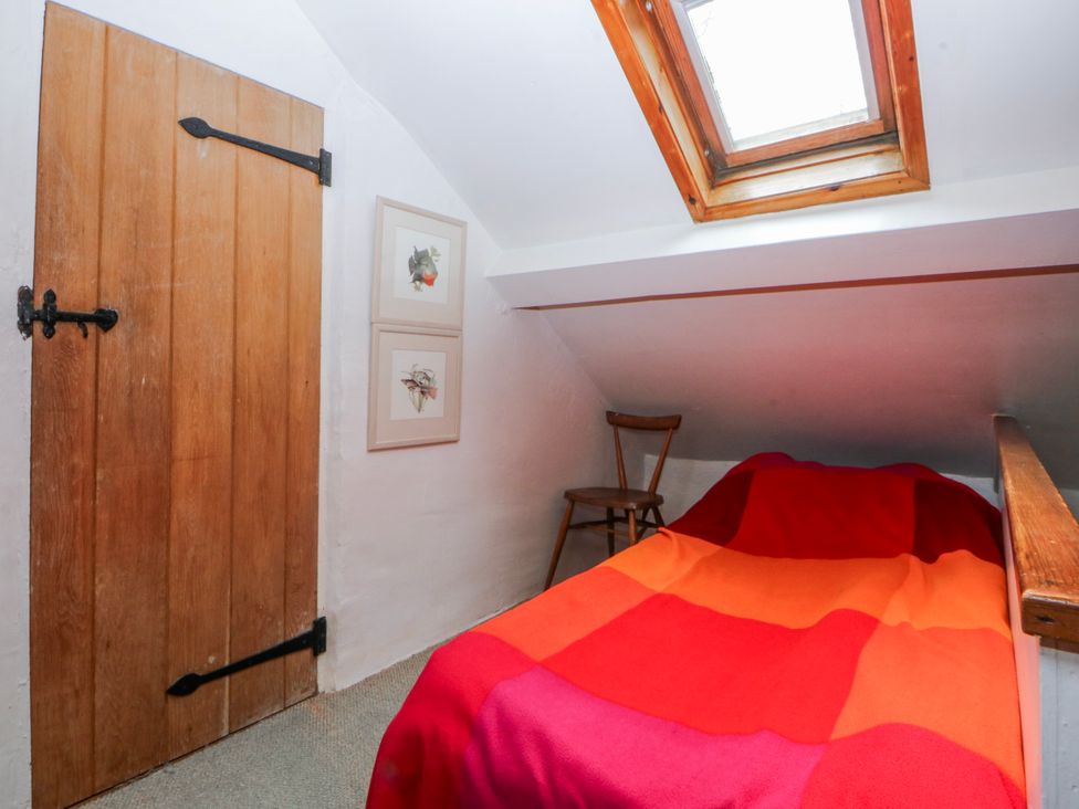 A bedroom with a bed and a skylight at Llwyn Y Brig Isaf in Caernarfon