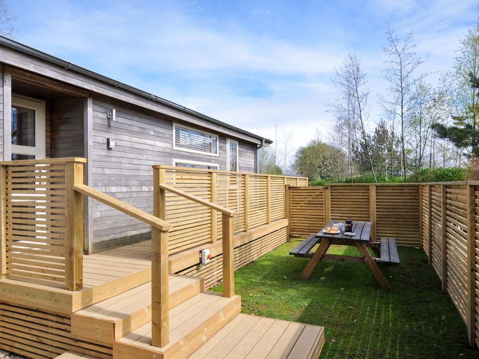 An outdoor space with a deck and picnic table at 3 Faraway Fields in Dobwalls