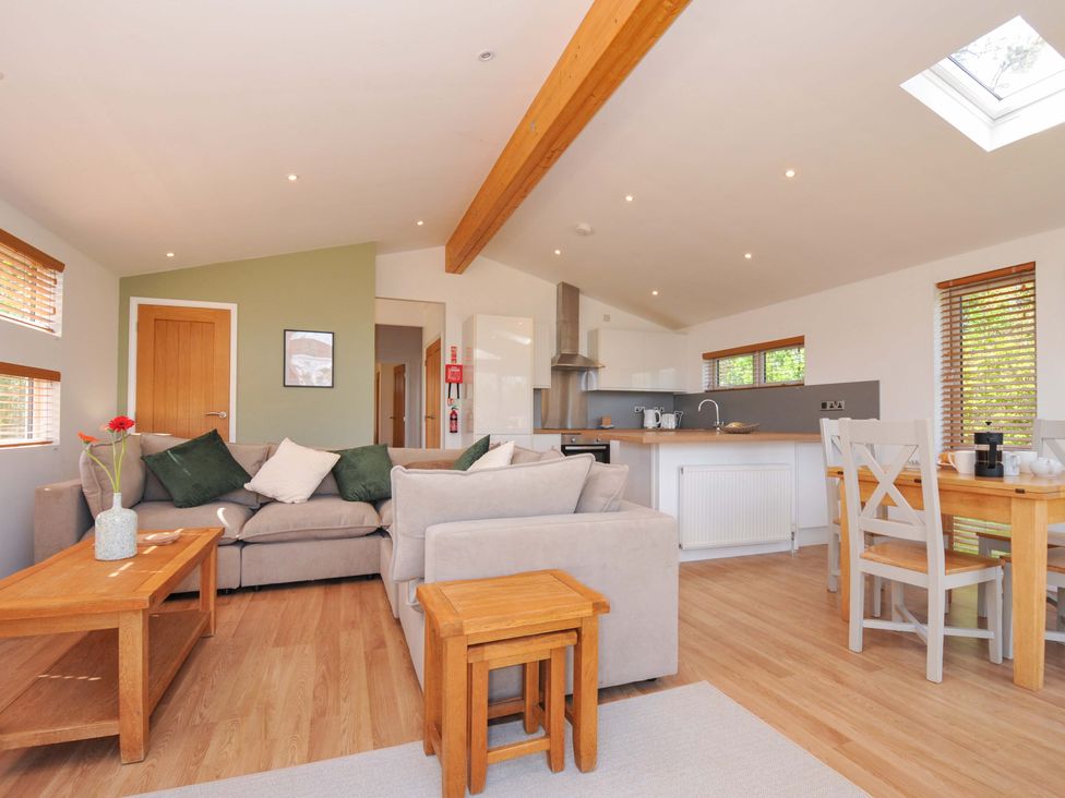 A living room with a sofa and dining table at 3 Faraway Fields in Dobwalls