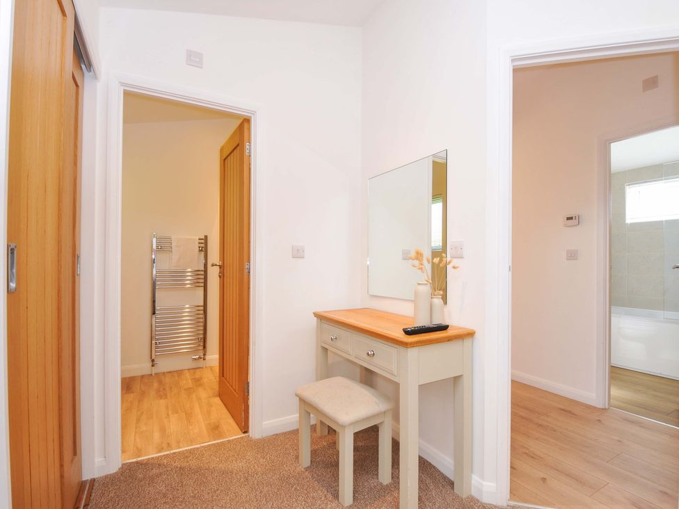 A hallway with a dressing table and mirror at 3 Faraway Fields in Dobwalls
