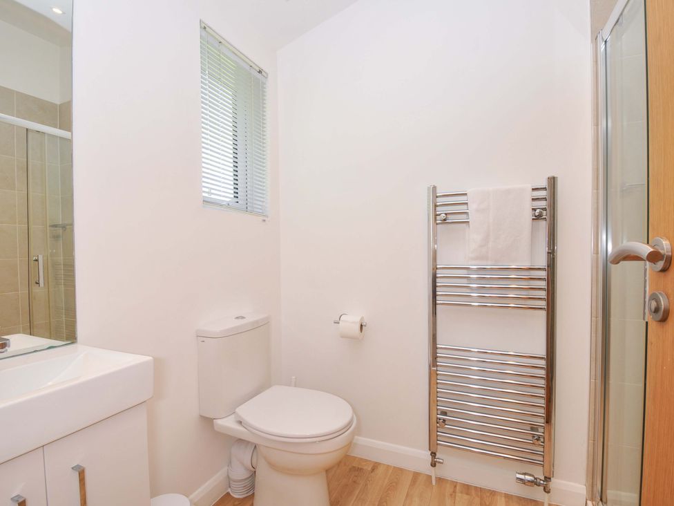 A bathroom with a toilet, sink, and shower at 3 Faraway Fields in Dobwalls