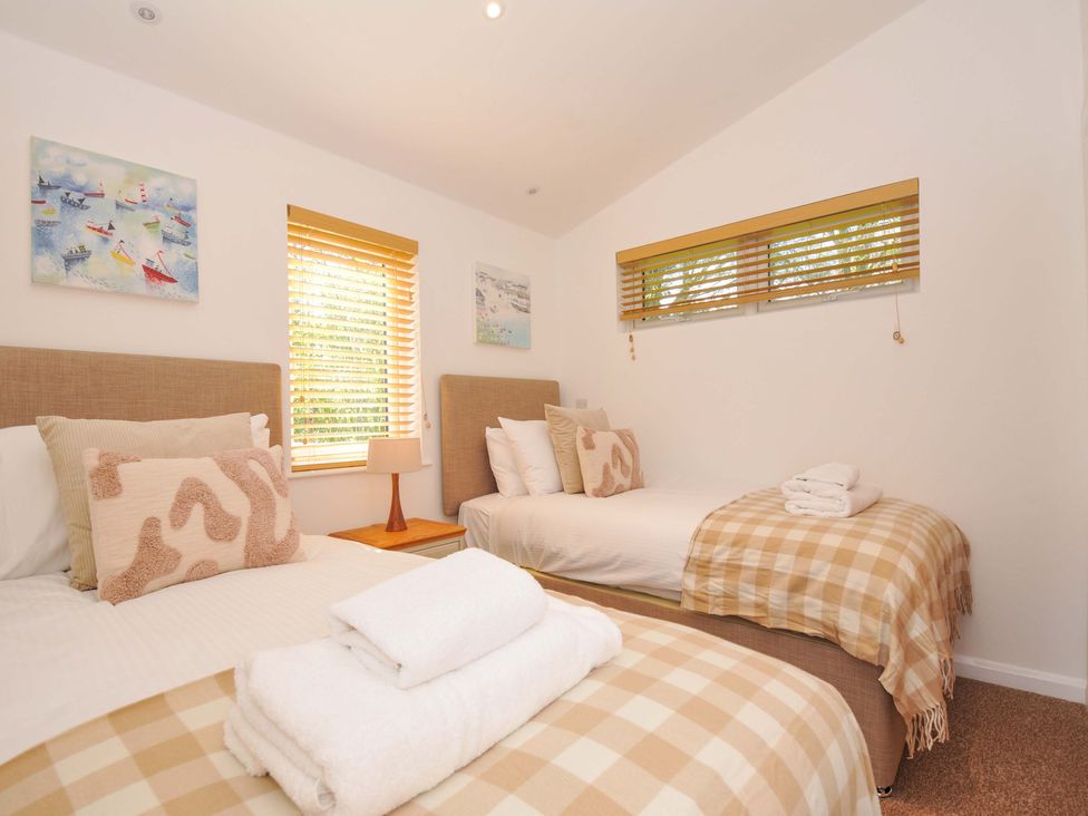 A bedroom with two beds and decorative artwork at 3 Faraway Fields in Dobwalls
