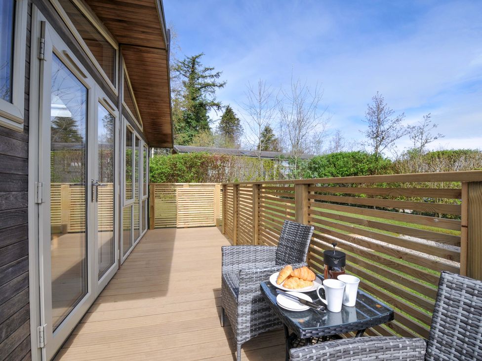An outdoor area with a table and chairs containing coffee and croissants at 3 Faraway Fields in Dobwalls