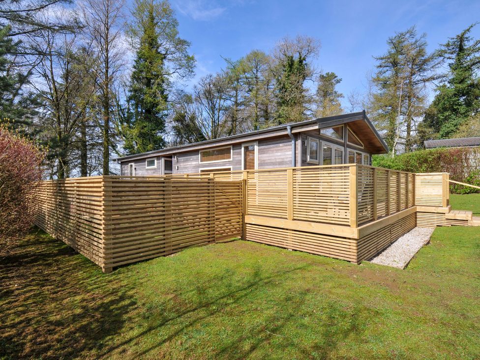 A cabin surrounded by wooden fencing and grass at 3 Faraway Fields in Dobwalls