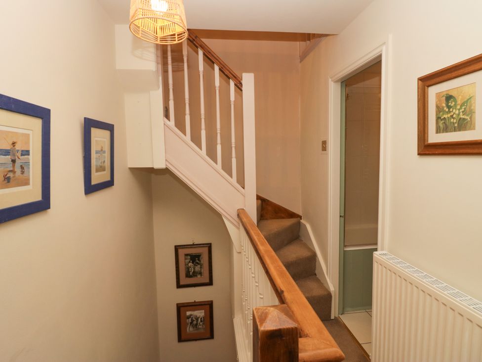 A hallway with stairs leading to the upper floor at Corner Cottage Lowick Green near Ulverston