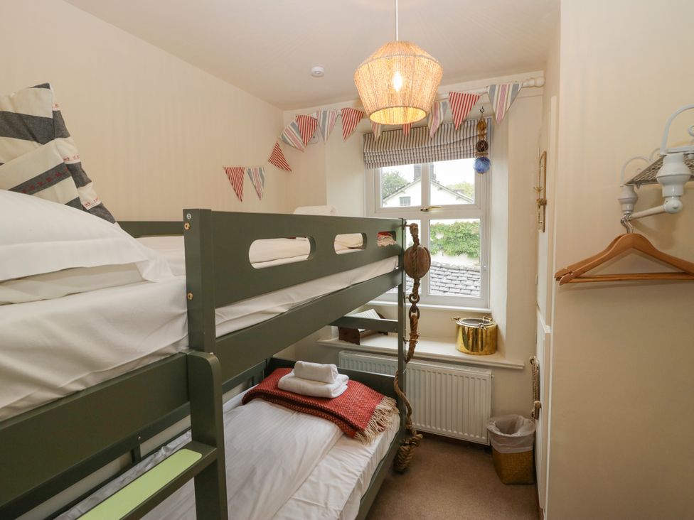 A bunk bed with pillows and blankets in Corner Cottage Lowick Green near Ulverston