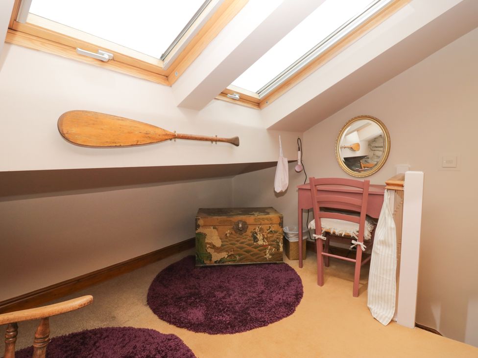 A loft with a storage chest and wooden paddle at Corner Cottage in Lowick Green near Ulverston