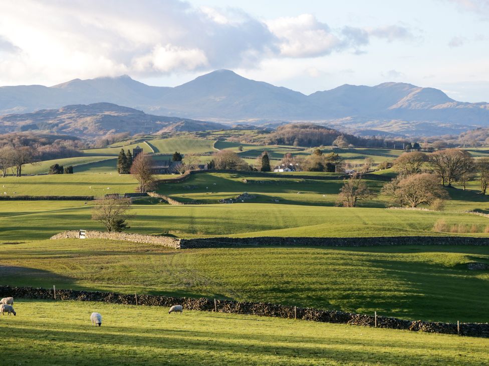 A landscape with mountains and grazing sheep at Corner Cottage Lowick Green near Ulverston