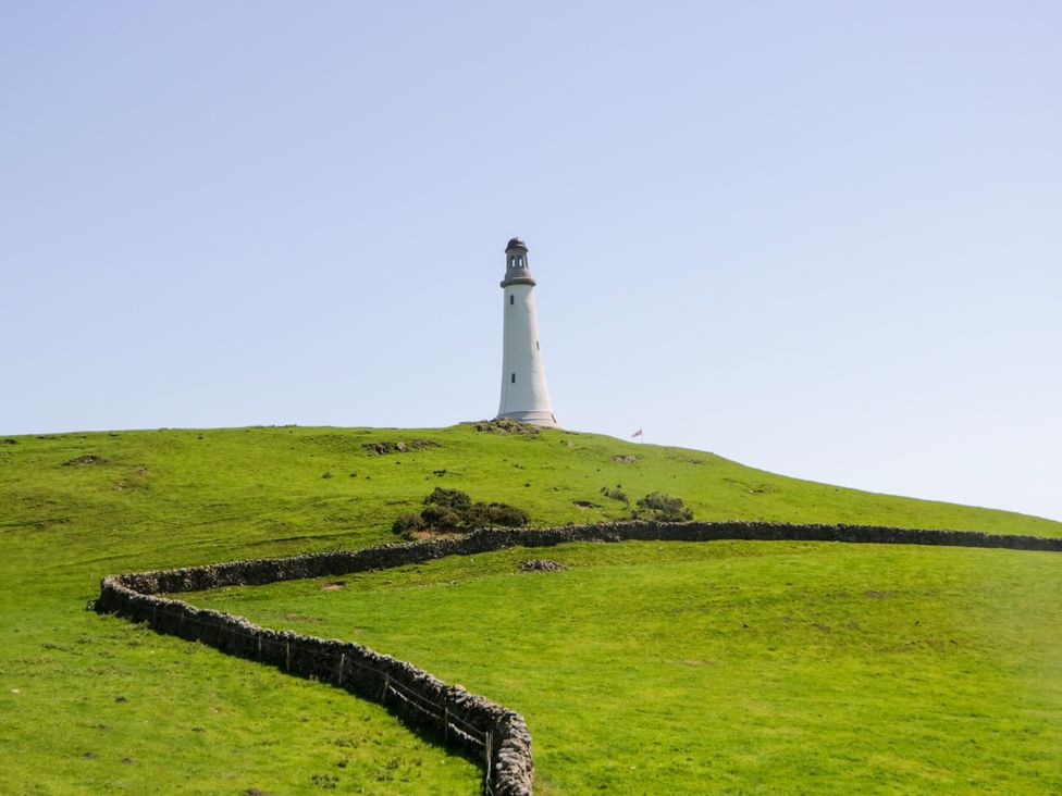 A lighthouse on a grassy hill at Corner Cottage Lowick Green near Ulverston
