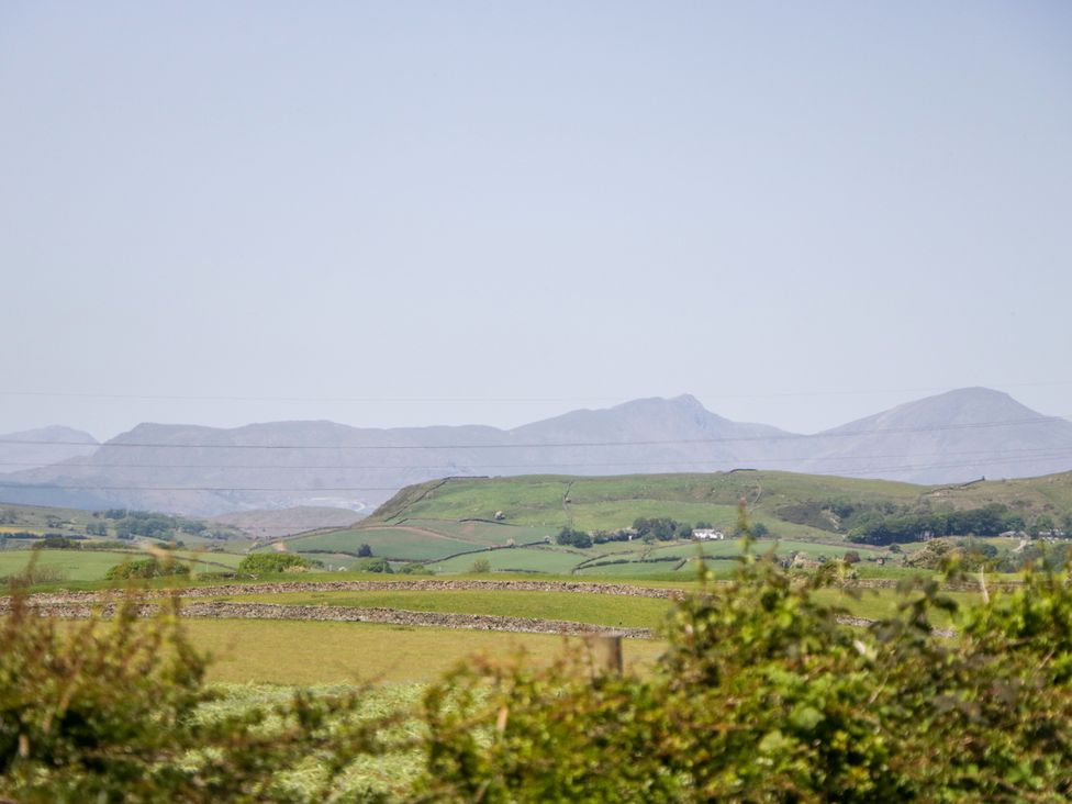A landscape with mountains and fields at Corner Cottage Lowick Green near Ulverston