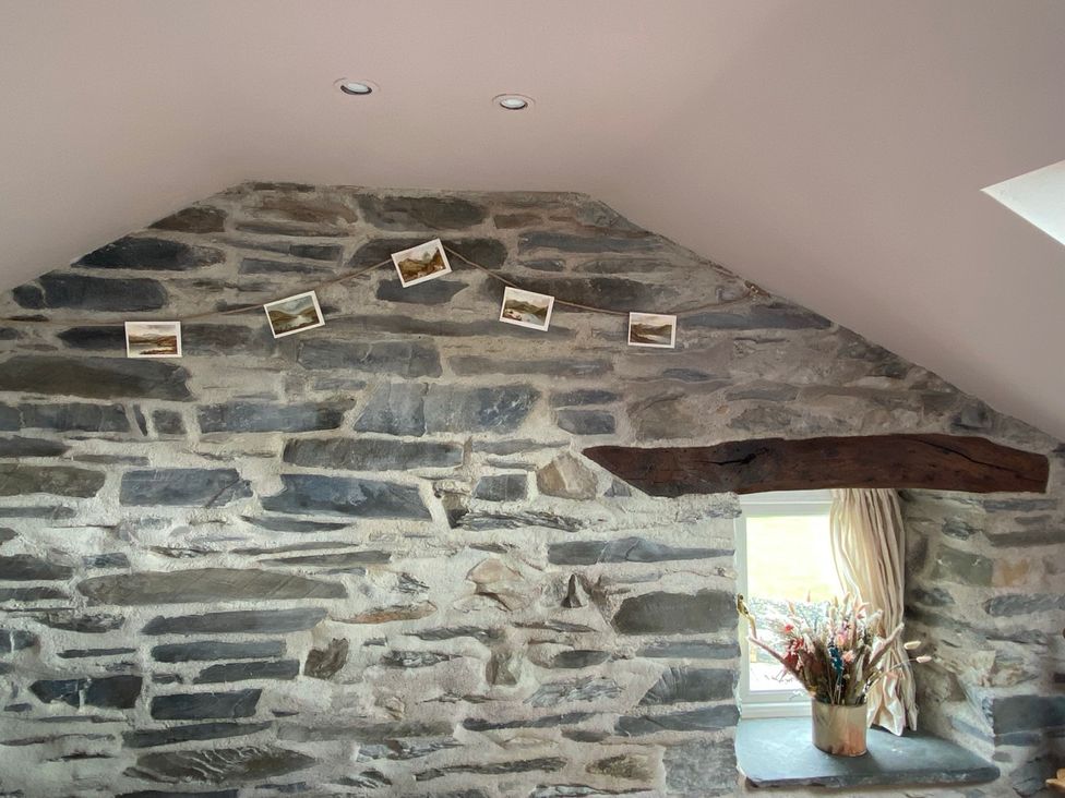 A snug with stone wall and pictures at Corner Cottage Lowick Green near Ulverston