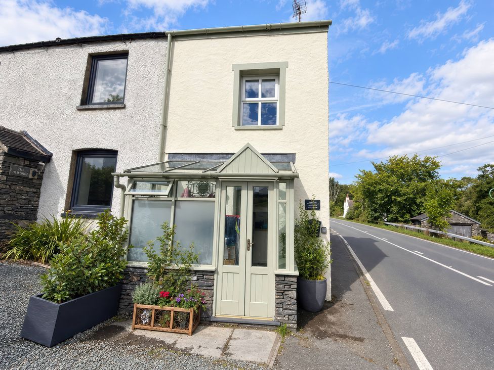 A house with plants and a glass entrance at Corner Cottage in Lowick Green near Ulverston