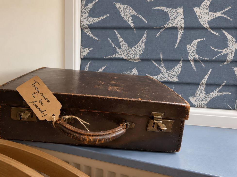 A suitcase with a tag on a table at Corner Cottage in Lowick Green near Ulverston