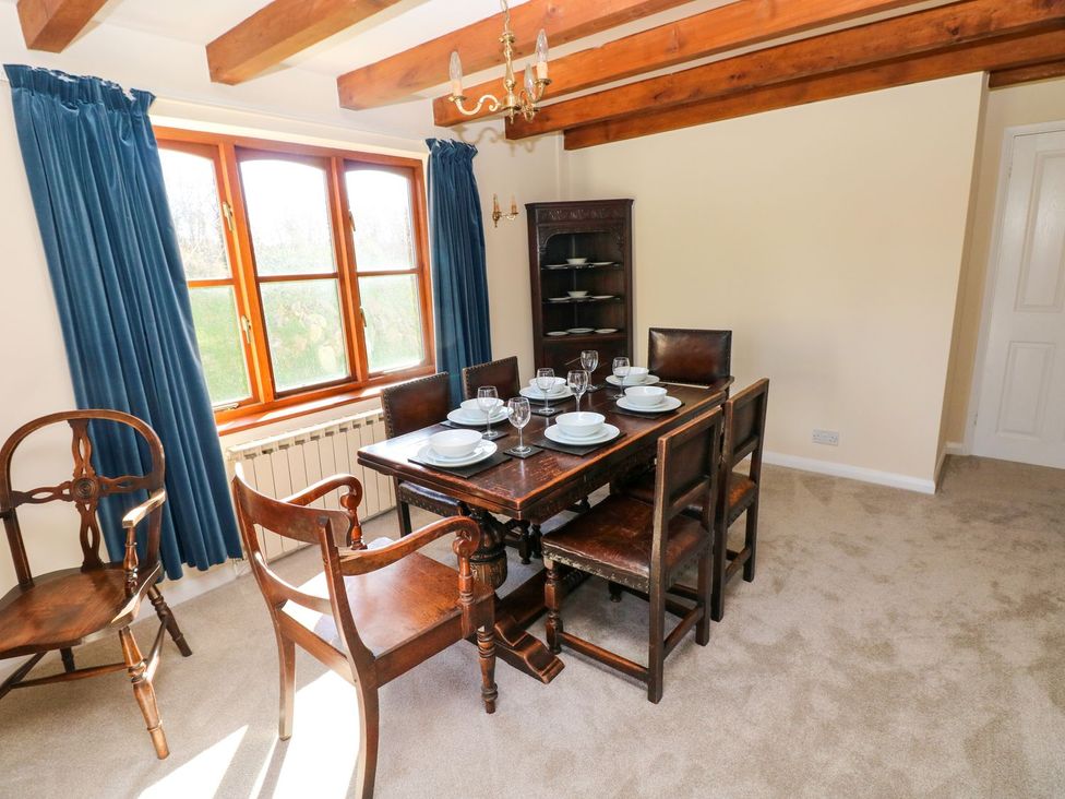 A dining room with table and chairs at Park Hall Cottage in Solva