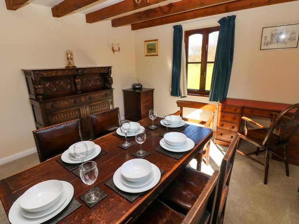 A dining room with a table set for dinner at Park Hall Cottage in Solva