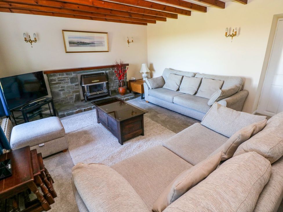 A living room with sofas and a coffee table at Park Hall Cottage Solva