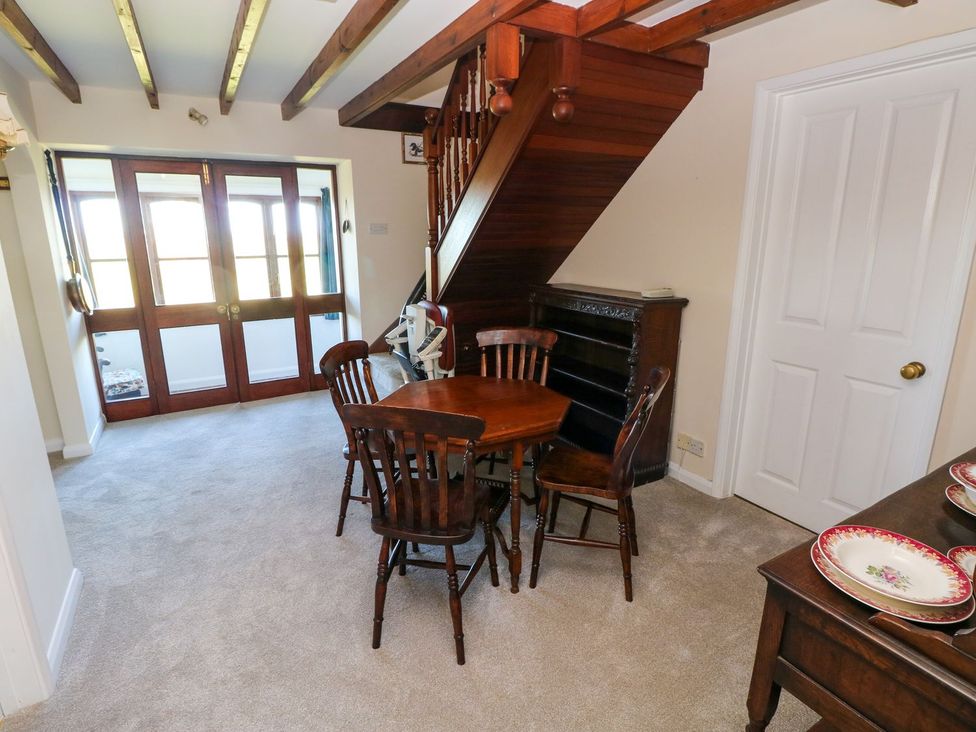 A dining room with a table and chairs at Park Hall Cottage Solva