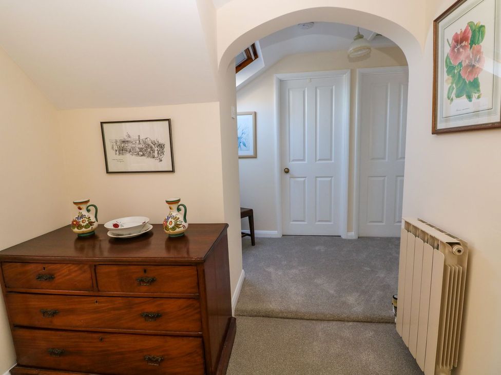 A hallway with a dresser and vases at Park Hall Cottage in Solva