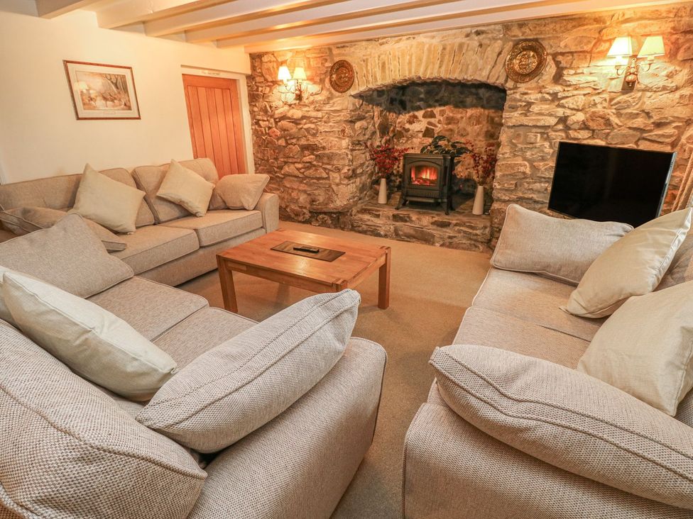A living room with sofas and a fireplace at Maerdy Lodge 