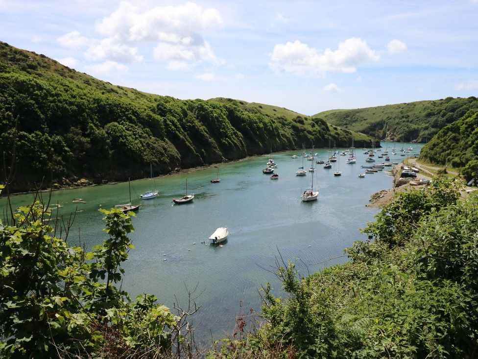 A view of boats in water with hills and trees at Maerdy Lodge