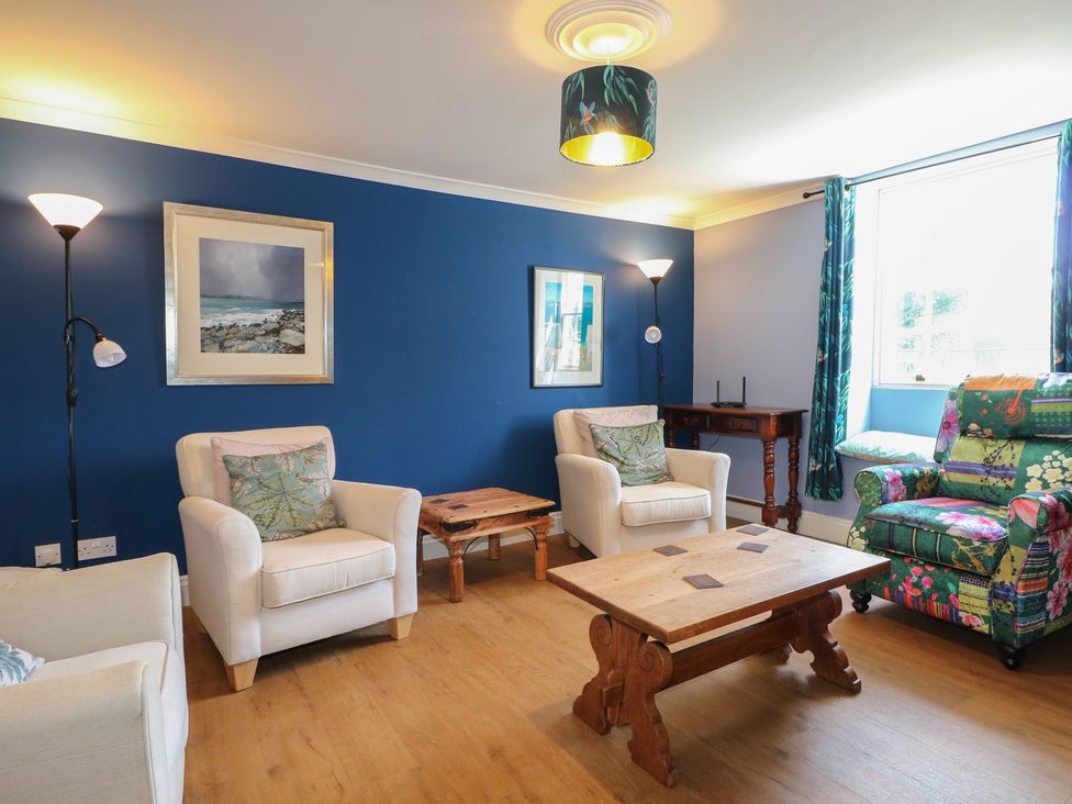 A living room with a sofa and armchairs at The Old School House in Chichester