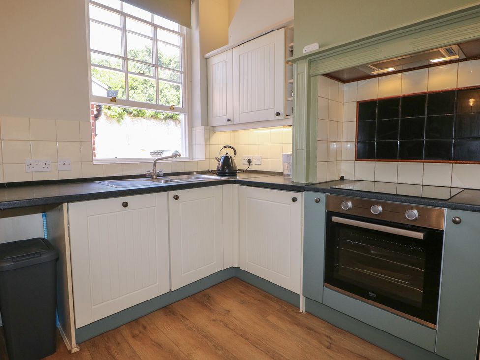 A kitchen with a sink and oven at The Old School House in Chichester