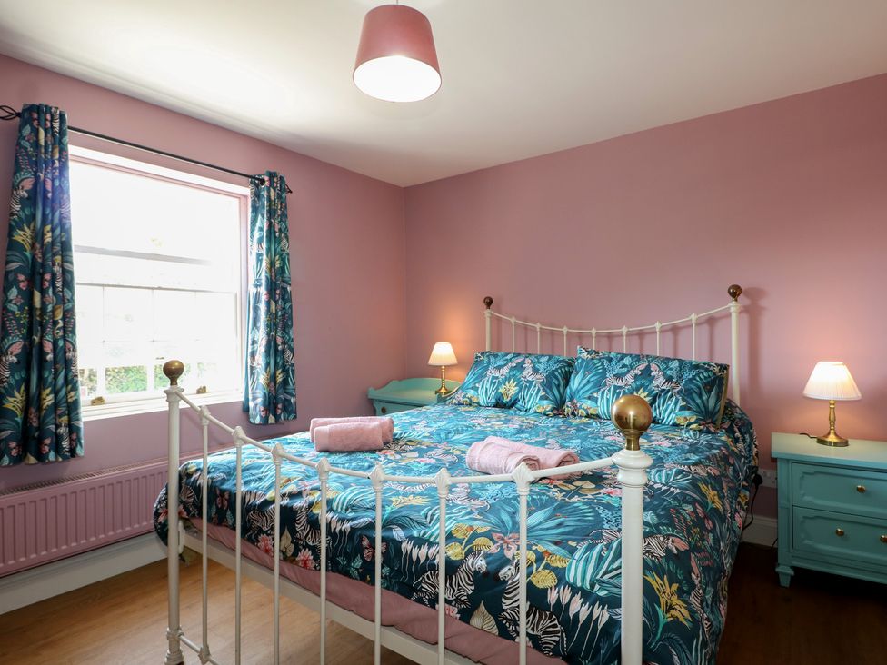 A bedroom with a bed and nightstand at The Old School House in Chichester