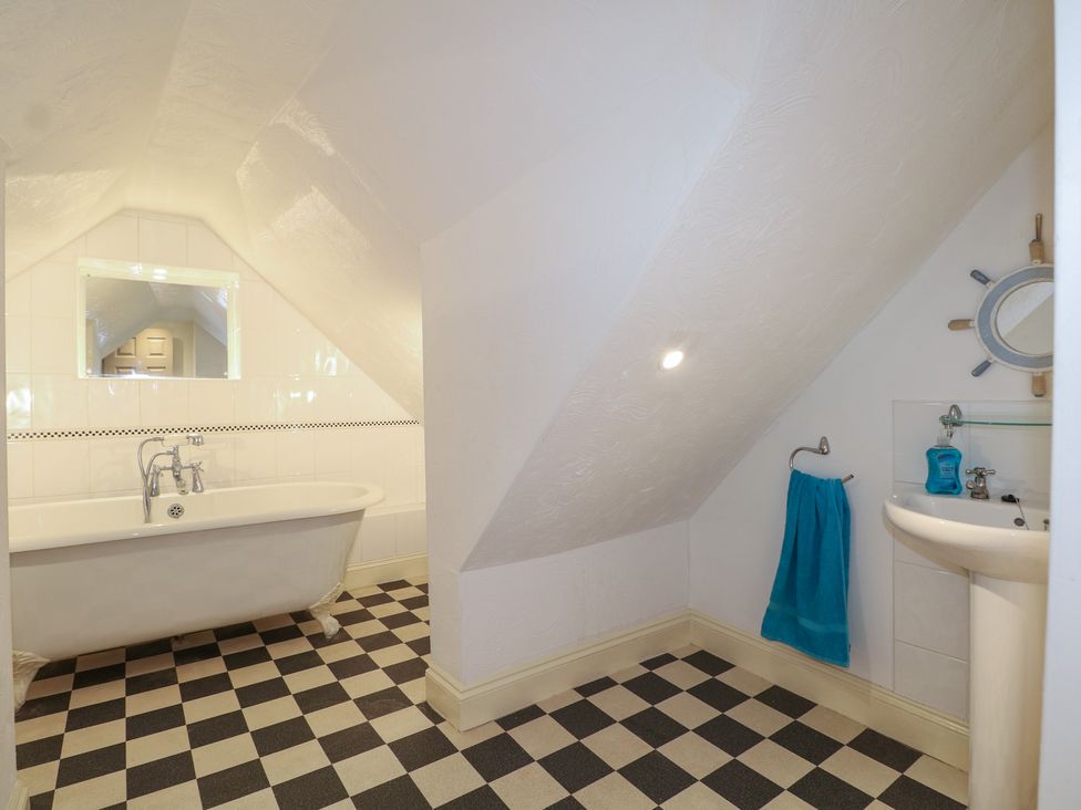 A bathroom with a bathtub and sink at The Old School House in Chichester
