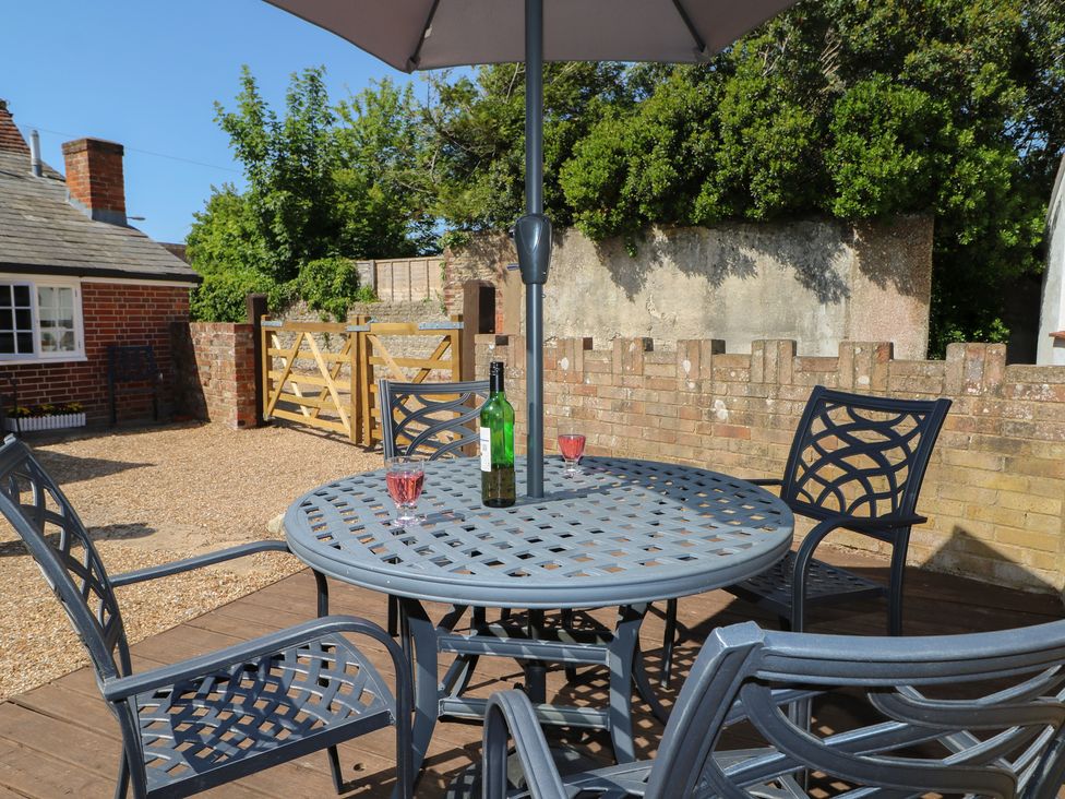 An outdoor seating area with a table and chairs at The Old School House in Chichester