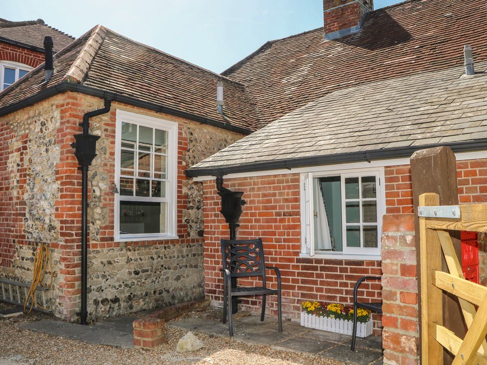 An outdoor area with a chair and planter at The Old School House in Chichester