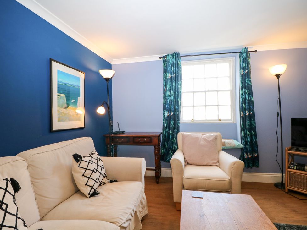 A living room with a sofa and armchair at The Old School House in Selsey