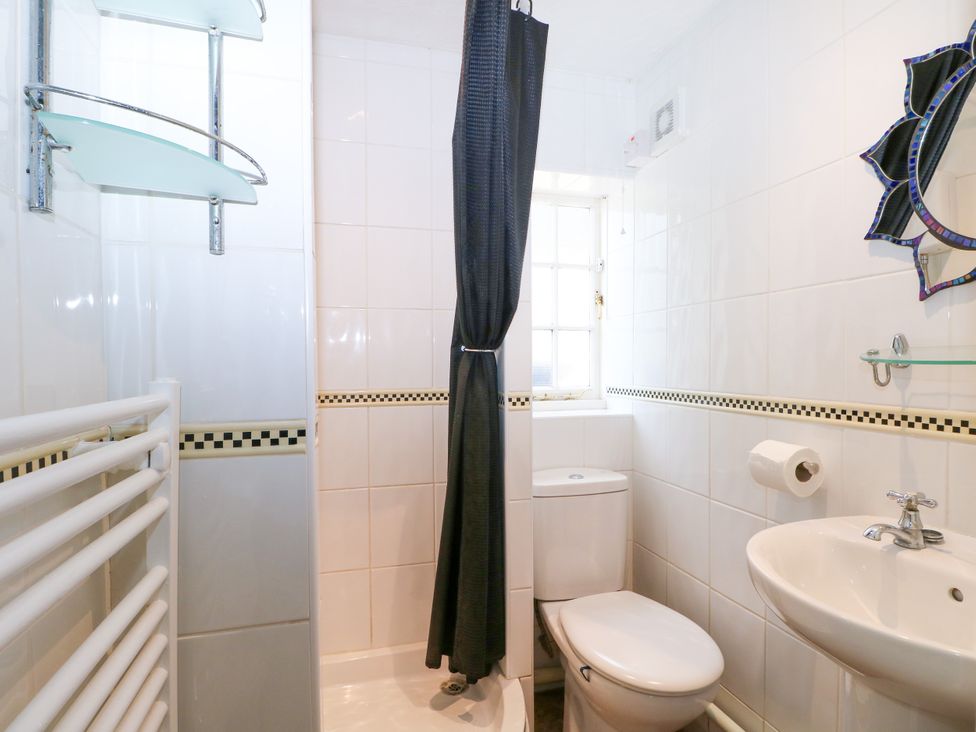 A bathroom with a shower, toilet, and sink at The Old School House in Selsey