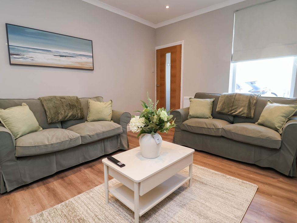 A living room with sofas and a coffee table at Brightside in Hoylake