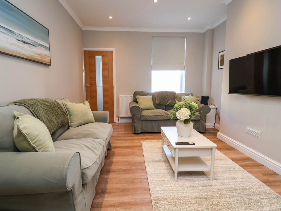 A living room with a sofa and coffee table at Brightside in Hoylake