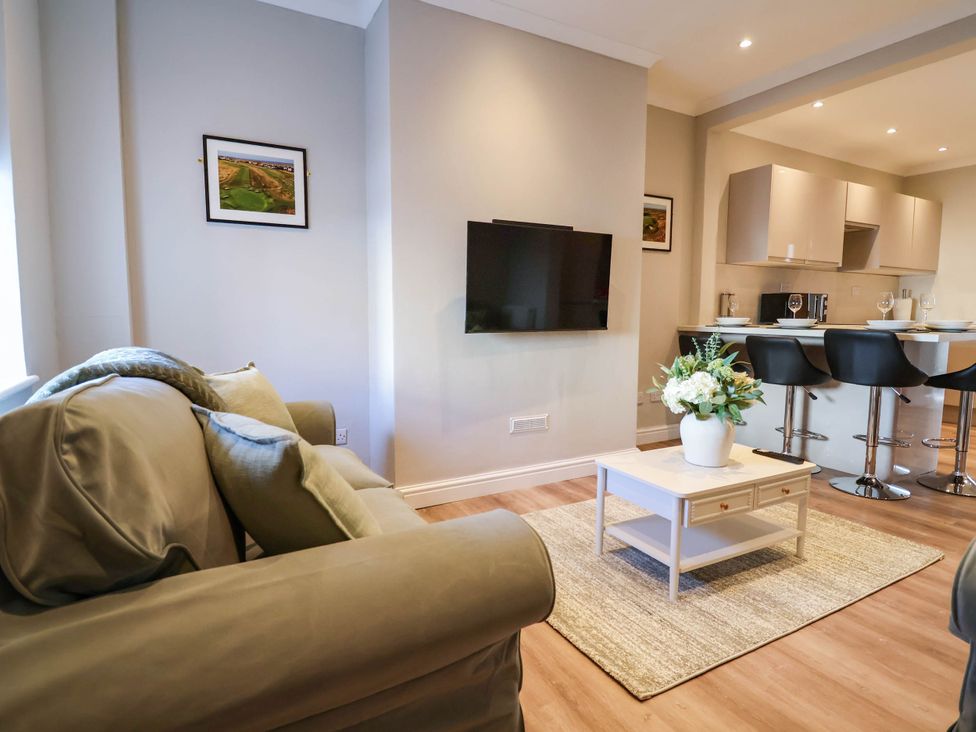 A living room with a sofa and coffee table at Brightside in Hoylake