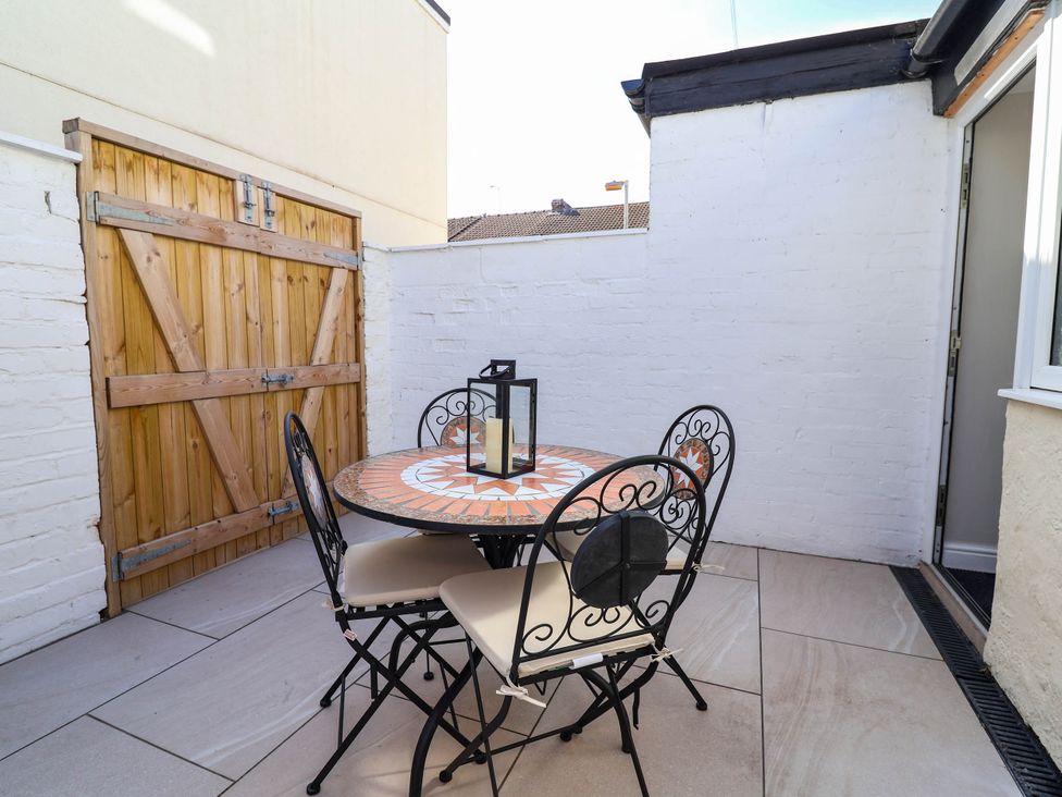 An outdoor space with a table and chairs at Brightside in Hoylake