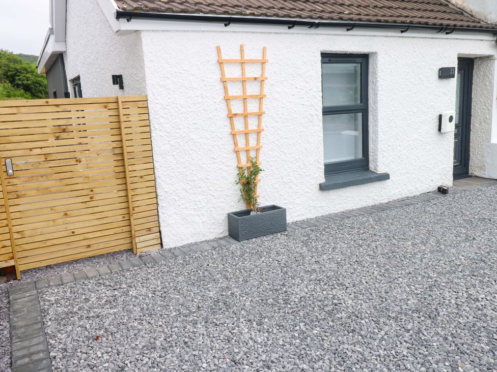 An outdoor area with a fence and planter at Y Bwthyn Burry Port