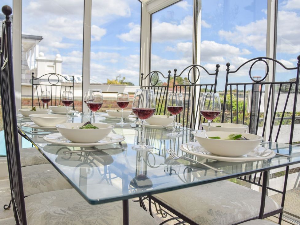 A dining table set with wine glasses and plates at Beresford House in Woodbridge