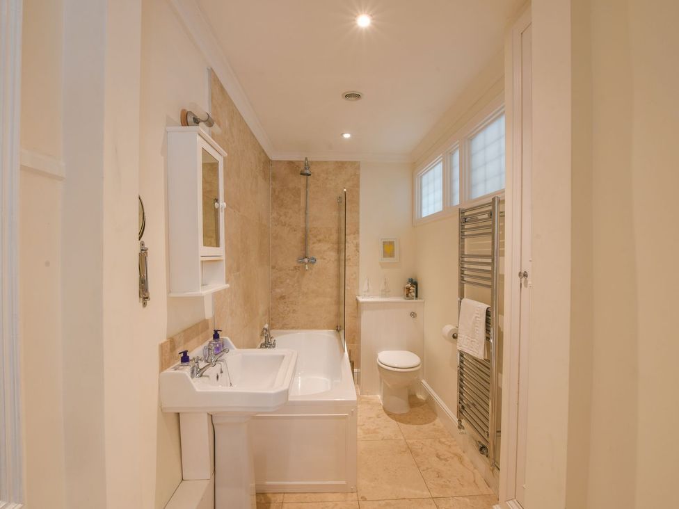 A bathroom with a bathtub, sink, toilet, and shower at Beresford House in Woodbridge