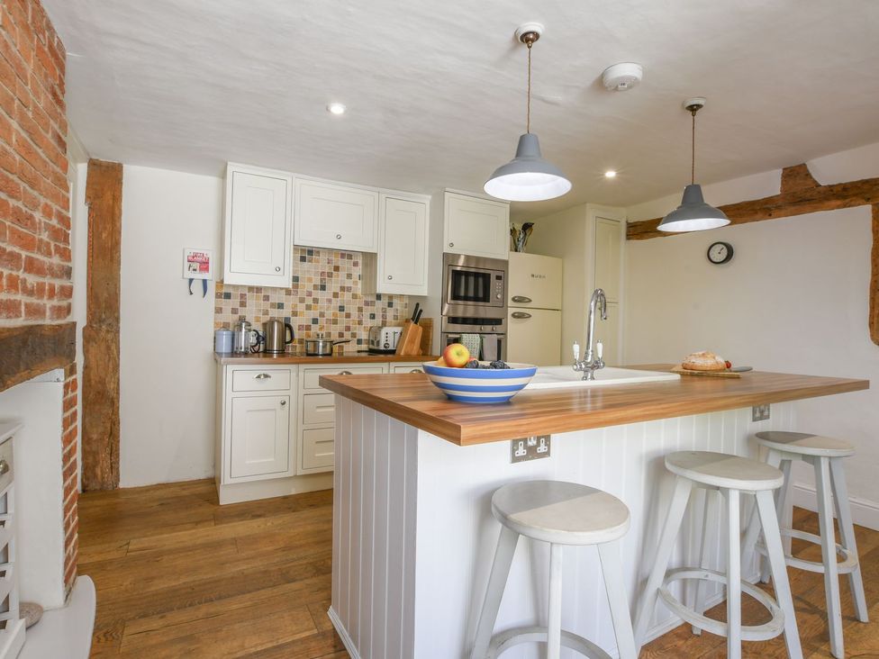 A kitchen with cabinets and island at Beresford House in Woodbridge