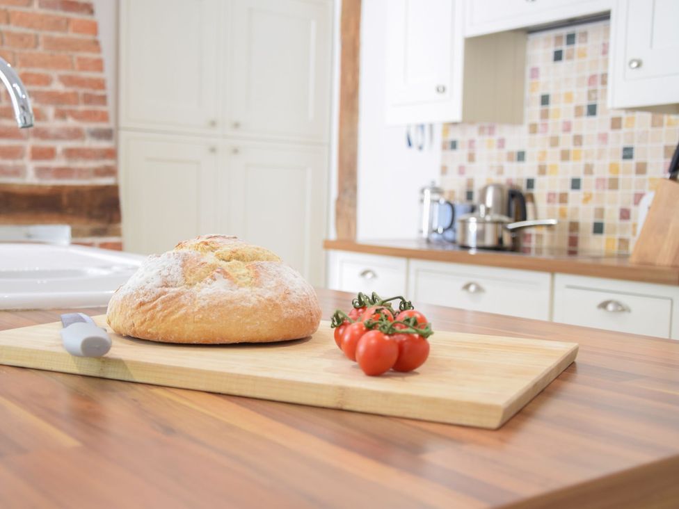 A kitchen with bread and tomatoes on a countertop at Beresford House in Woodbridge