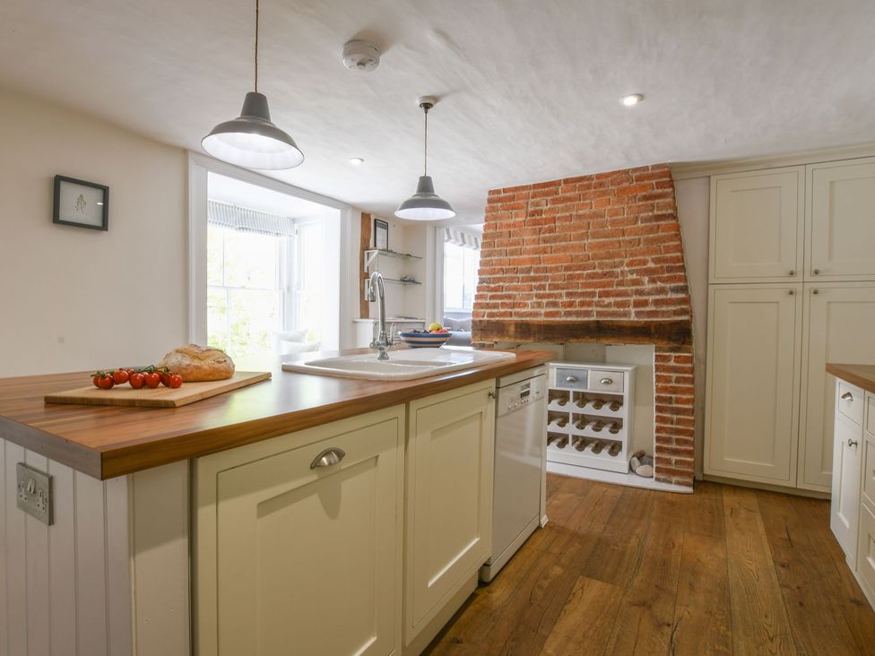 A kitchen with a sink and island at Beresford House in Woodbridge