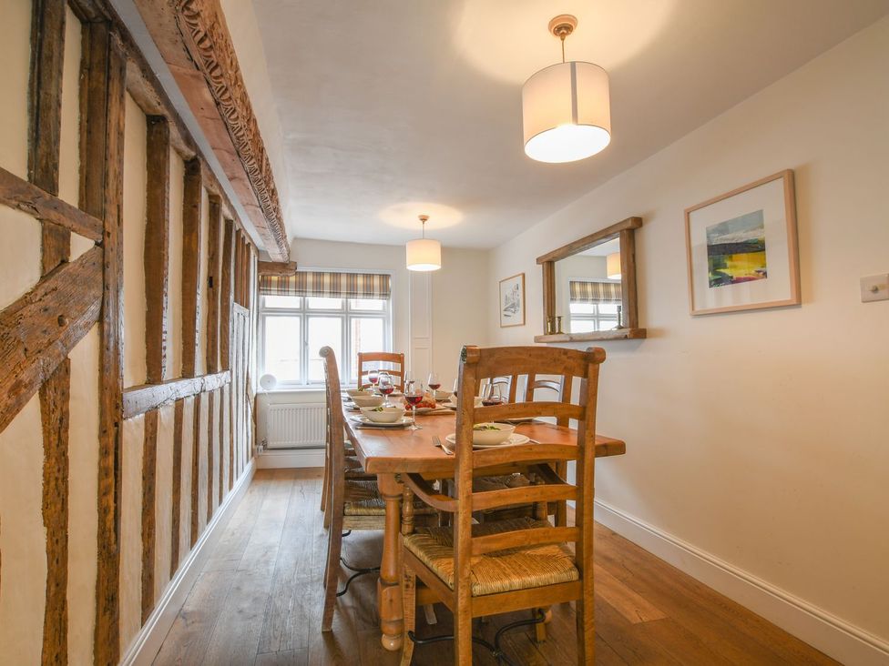 A dining room with a wooden table and chairs at Beresford House, Woodbridge