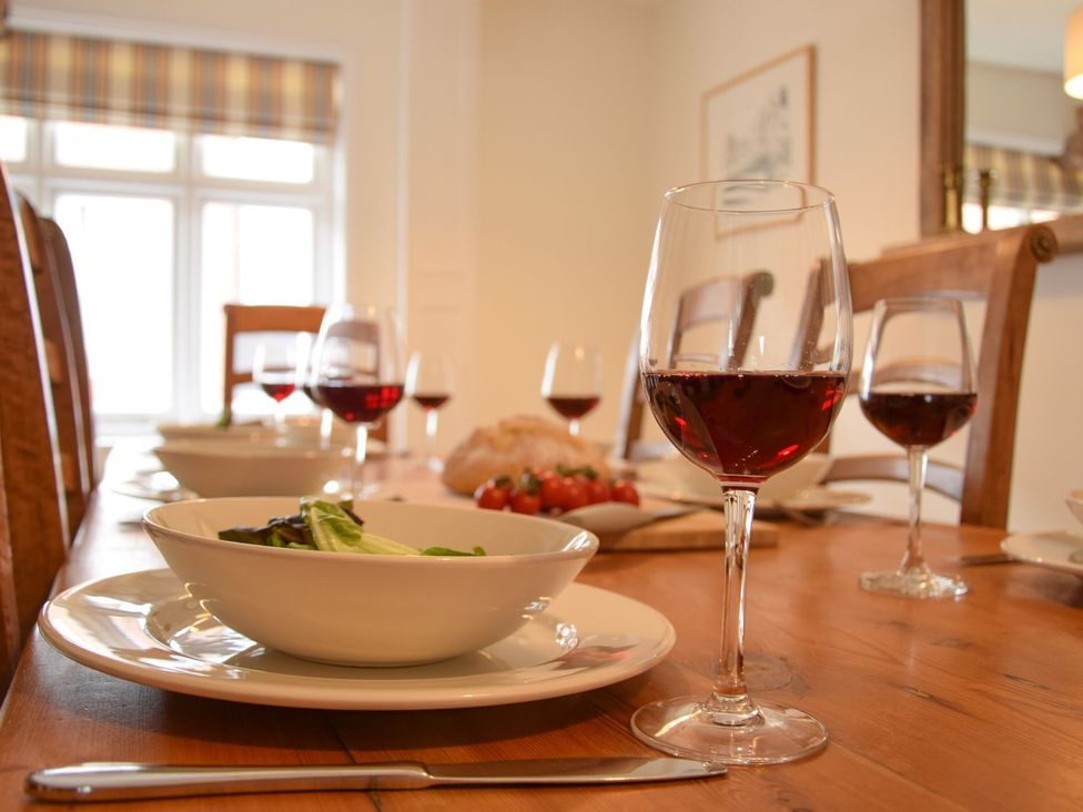 A dining room with a table set for a meal at Beresford House in Woodbridge